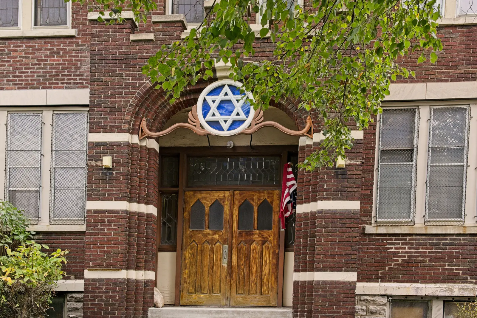 The carved front doors beneath the round window