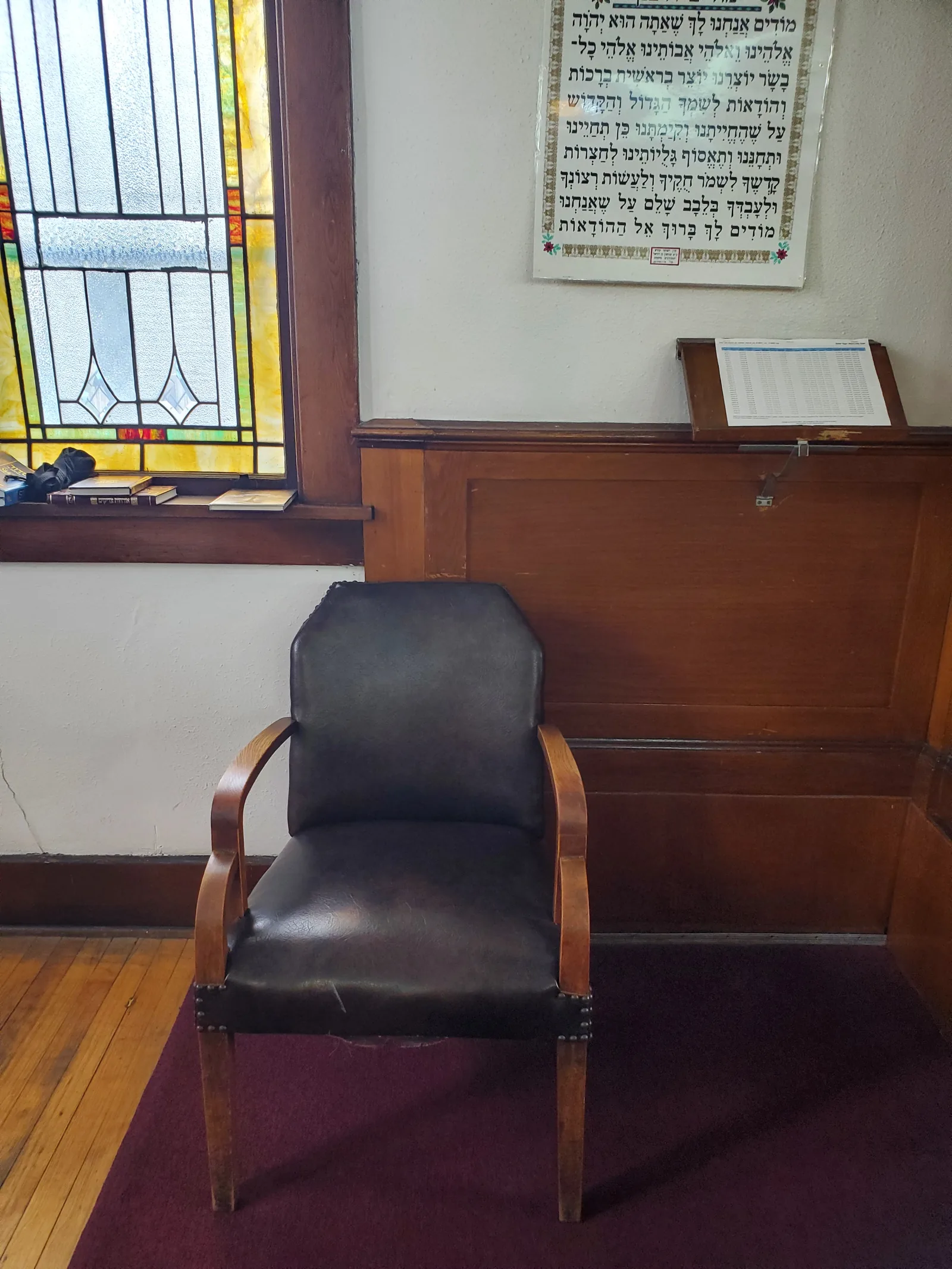 Pews beside a leaded glass window