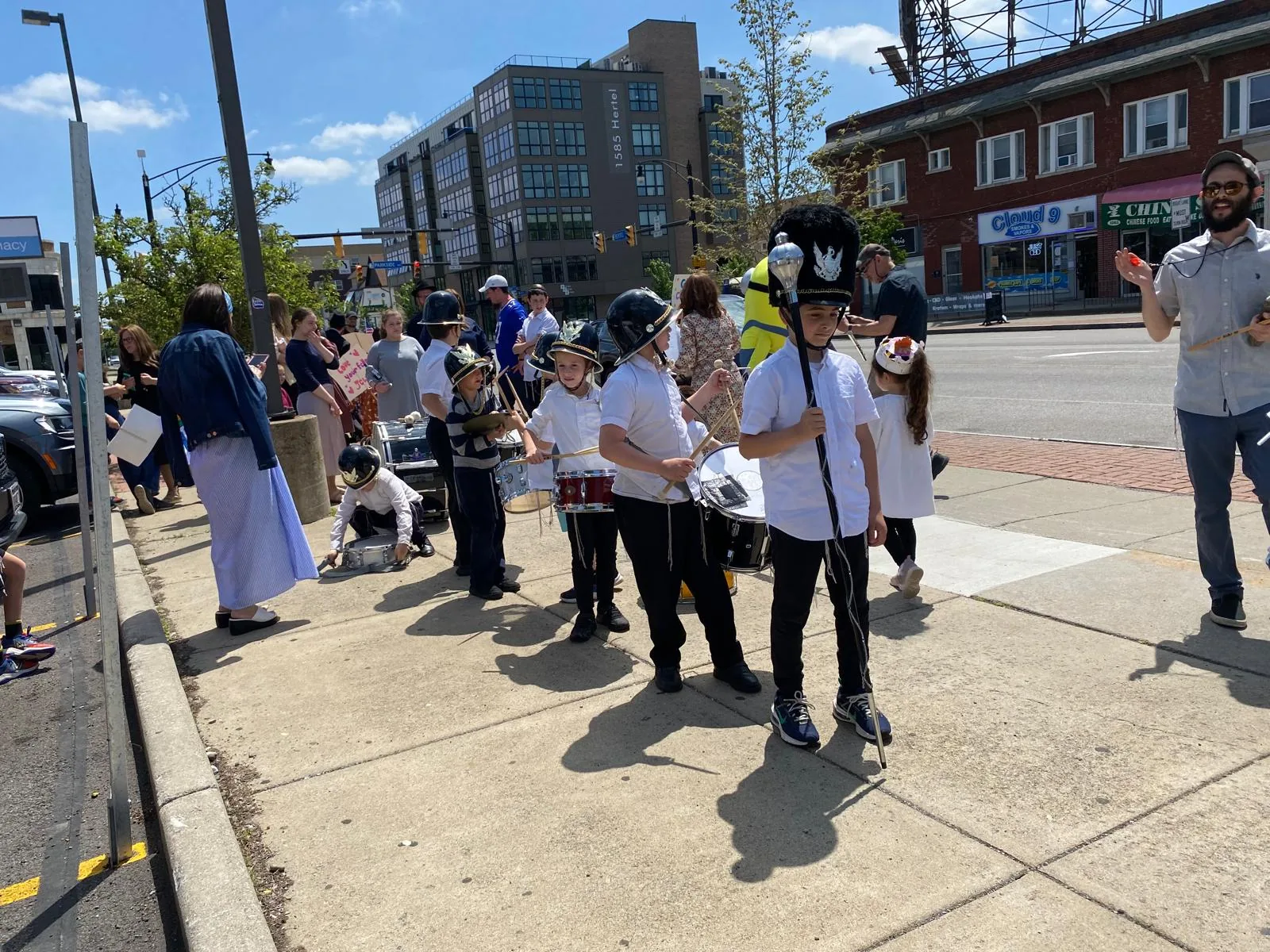 Marchers and onlookers along the parade route