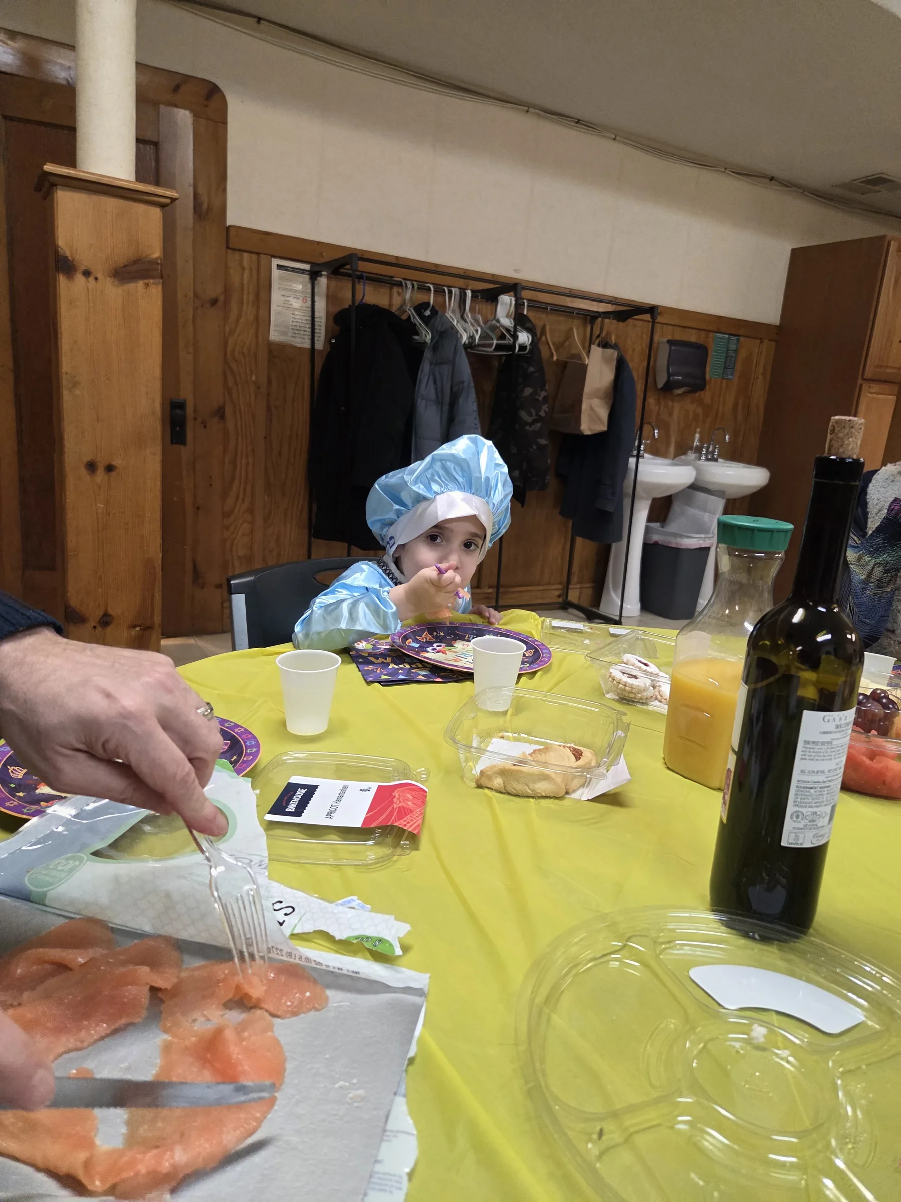 The social hall filled with tables for the Purim seudah