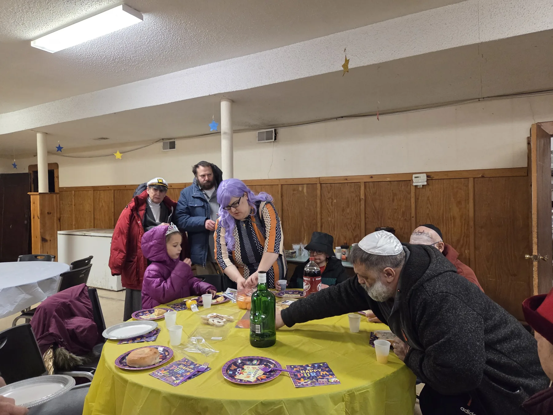 Guests around a table at the Purim seudah