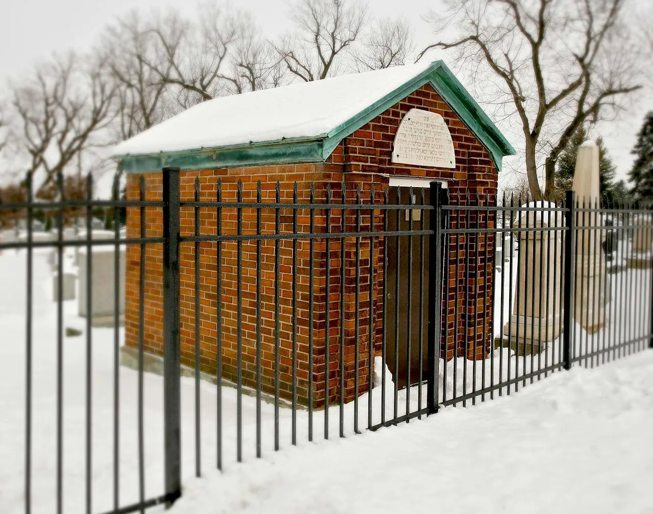 The brick ohel of Rabbi Rabinowitz in the snow