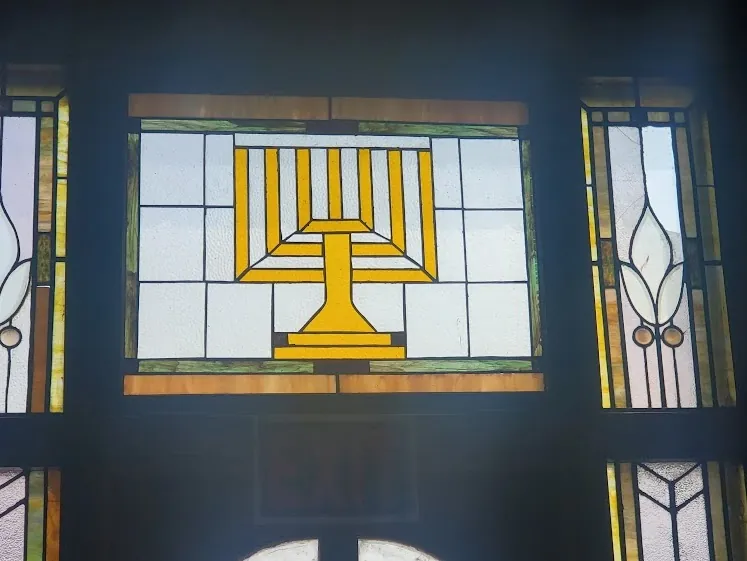 A stained-glass window with a menorah