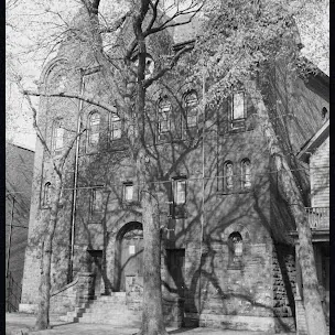 The Bris Sholem shul among bare trees, in an old photograph