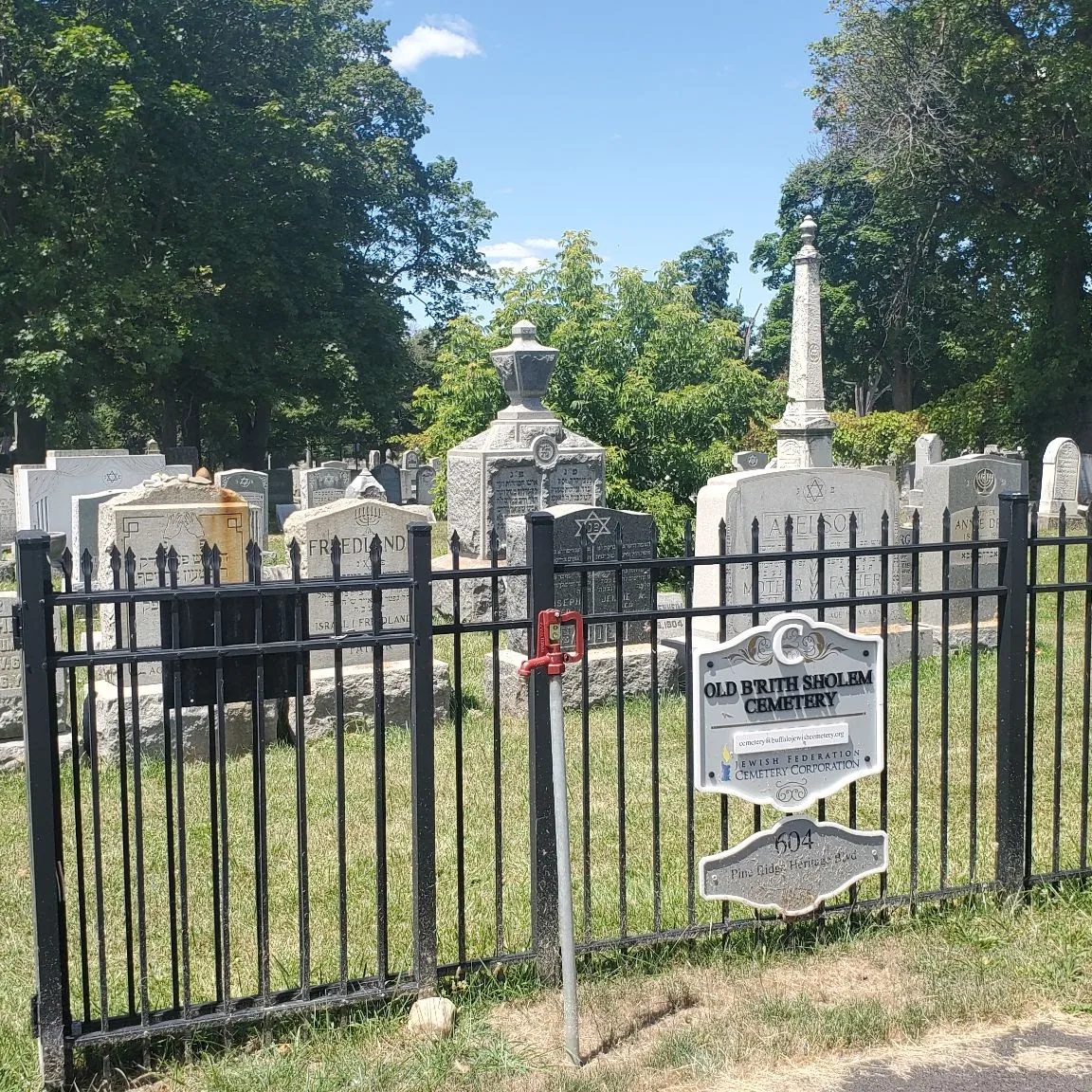 The fenced Old Bris Shalom Cemetery and its historical marker