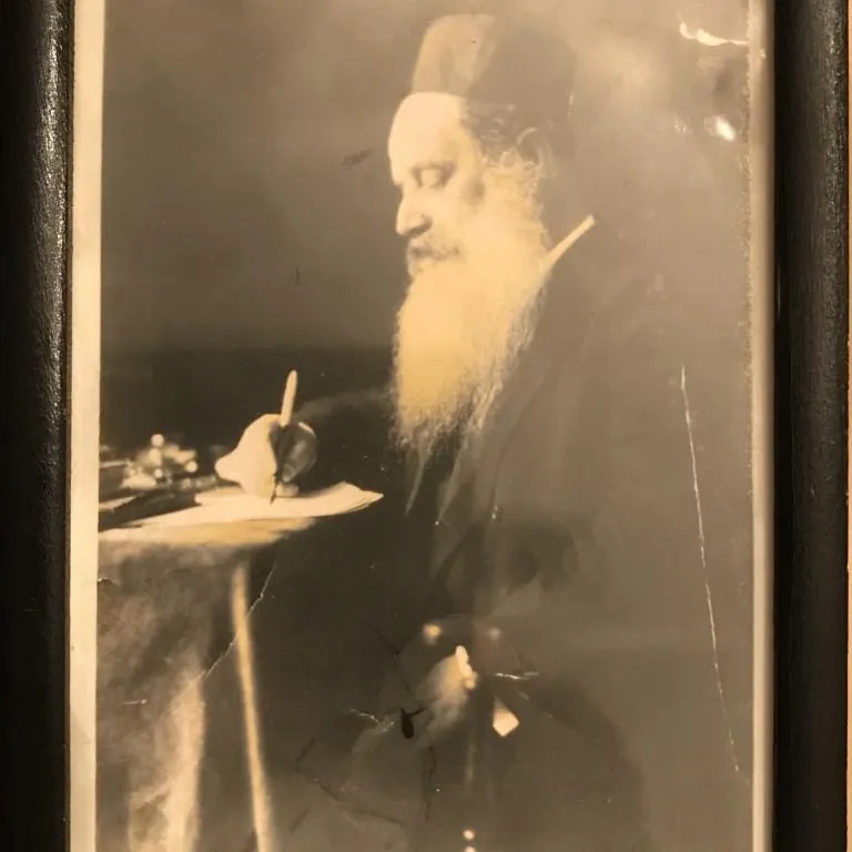 Rabbi Zambrowski writing at a table